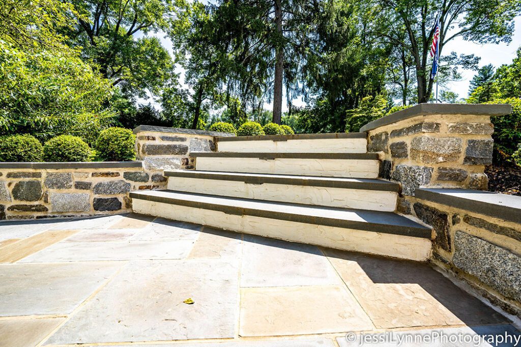 stone floored deck with stairs to yard