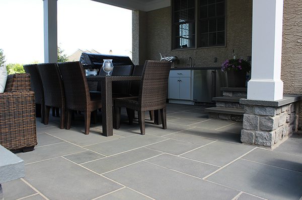 Gray stone patio with chairs and outdoor seating